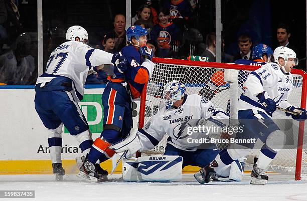 Victor Hedman and goaltender Anders Lindback of the Tampa Bay Lightning defend against David Ullstrom of the New York Islanders at the Nassau...