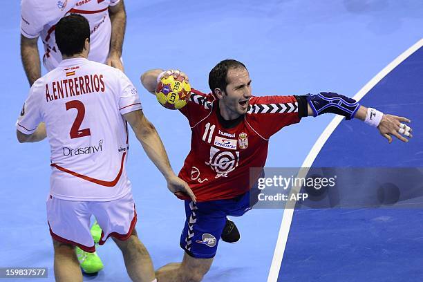 Serbia's pivot Alem Toskic shoots past Spain's left back Alberto Enterrios during the 23rd Men's Handball World Championships round of 16 match...