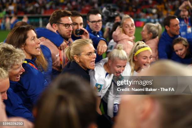 Sarina Wiegman, Manager of England, celebrates victory with the England players and staff following a penalty shoot out during the FIFA Women's World...