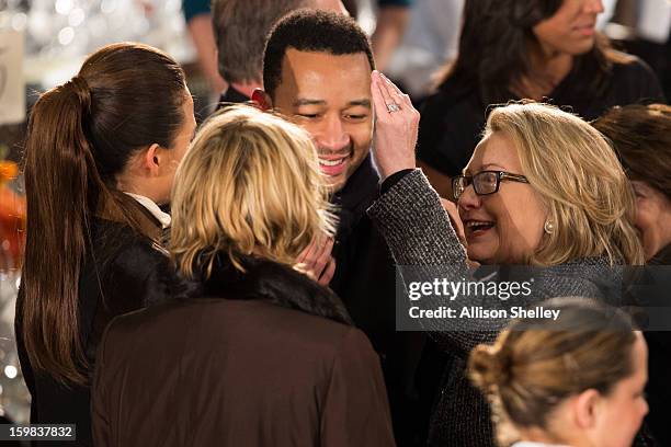 Secretary of State Hillary Clinton greets singer John Legend and his fiance Christine Teigen at the Inaugural Luncheon in Statuary Hall on...