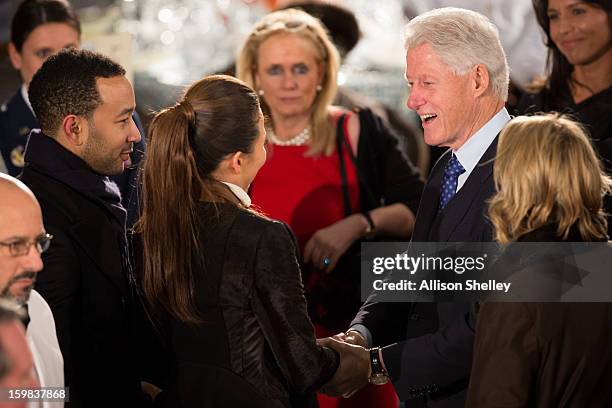 Former U.S. President Bill Clinton greets singer John Legend and his fiance Christine Teigen at the Inaugural Luncheon in Statuary Hall on...