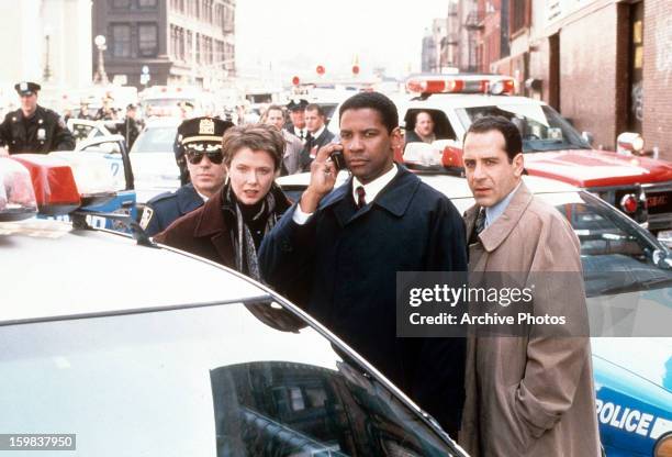 Annette Bening, Denzel Washington and Tony Shalhoub at a disastrous situation in a scene from the film 'The Siege', 1998.