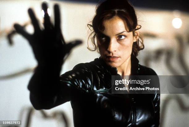 Famke Janssen holds up her hand in a scene from the film 'X-Men', 2000.