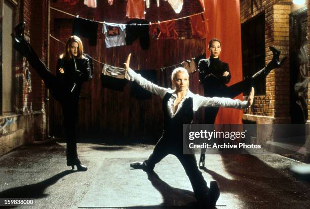 Cameron Diaz, Drew Barrymore and Lucy Liu all sporting a different leggy pose in a scene from the film 'Charlie's Angels', 2000.