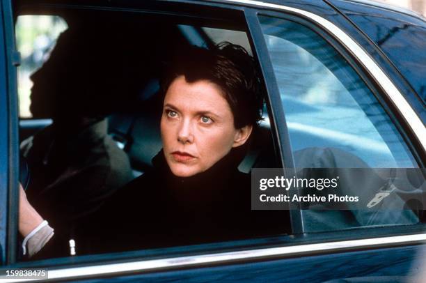 Annette Bening sitting in a car in a scene from the film 'The Siege', 1998.