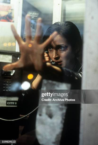 Carrie-Anne Moss in phone booth in a scene from the film 'The Matrix', 1999.