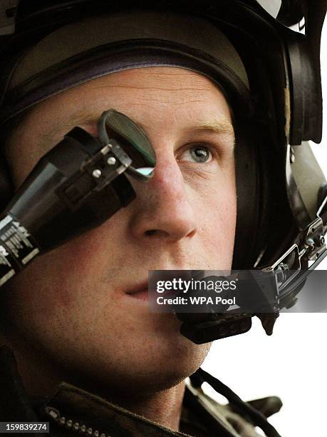 In this image released on January 21 Prince Harry, wears his monocle gun sight as he sits in the front seat of his cockpit at the British controlled...