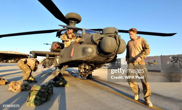 In this image released on January 21 Prince Harry does a pre-flight check of his Apache Helicopter after starting his 12 hour VHR shift at the...