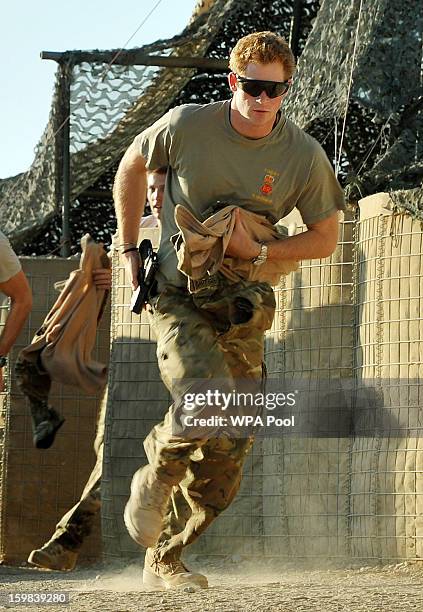 In this image released on January 21 Prince Harry races out from the VHR tent to scramble his Apache with fellow pilots, during his 12 hour shift at...