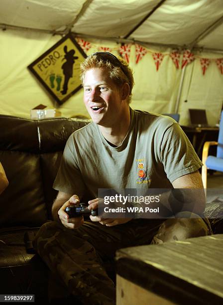 In this image released on January 21 Prince Harry relaxes as he plays a computer football game during a 12 hour VHR shift at the British controlled...