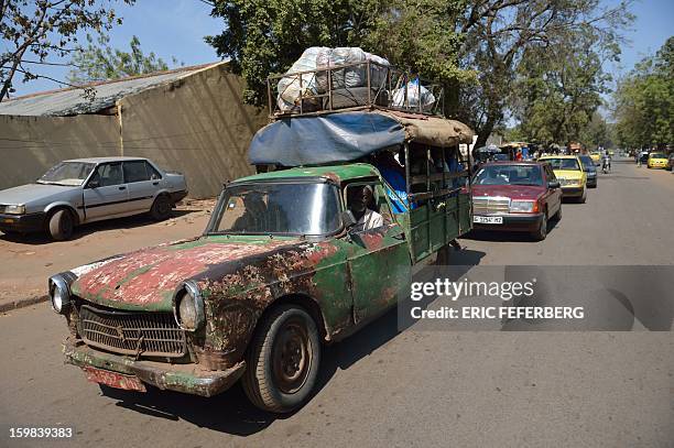 Peugeot 404 pick-up used as a taxi is pictured on January 21, 2013 in a street of Bamako. French and Malian troops recaptured the key towns of...