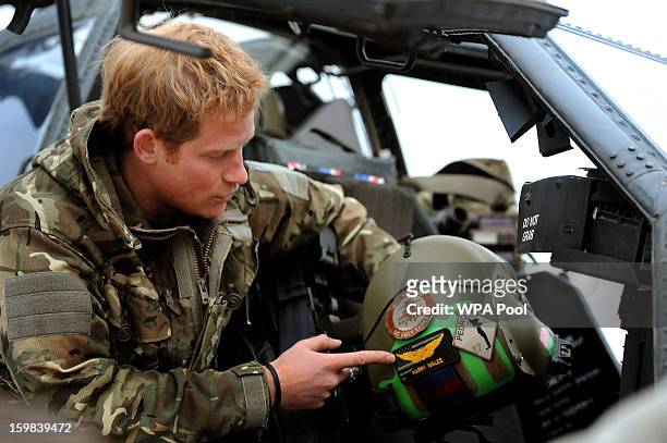 In this image released on January 21 Prince Harry makes his early morning pre-flight checks on the flight-line, at Camp Bastion on December 12, 2012...