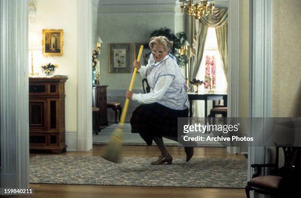 Robin Williams brooms in a scene from the film 'Mrs. Doubtfire', 1993.