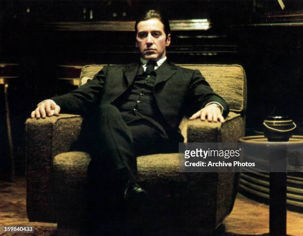 Al Pacino sits in a chair in a scene from the film 'The Godfather: Part II', 1974.