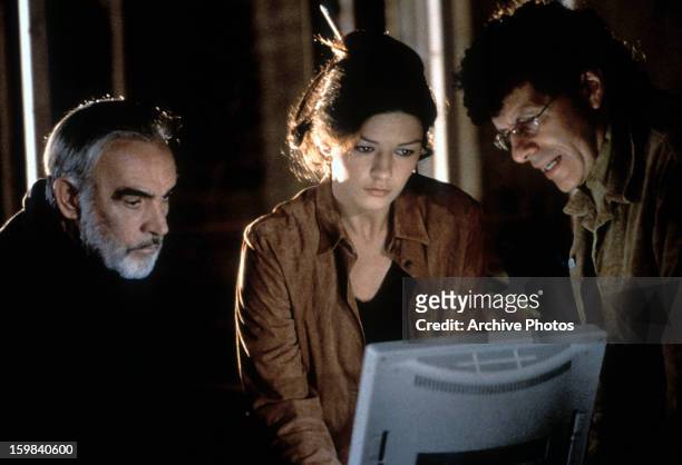 Sean Connery and Catherine Zeta-Jones looking at computer screen in a scene from the film 'Entrapment', 1999.