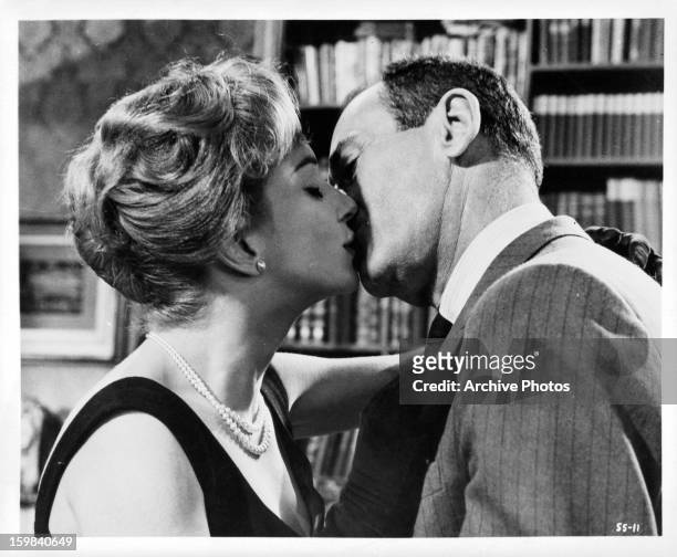 Henry Fonda and Fran Jeffries locked in a kiss in a scene from the film 'Sex and the Single Girl', 1964.