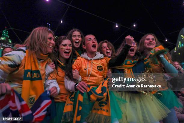 Australia fans celebrate at Melbourne's Federation Square after the Matildas scored the opening goal in their FIFA World Cup round of 16 match...