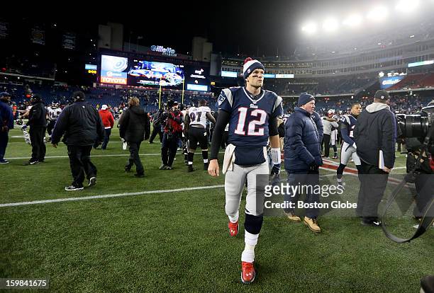 New England Patriots quarterback Tom Brady glances at the scoreboard as he leaves the field after the Patriots were defeated by the Baltimore Ravens...