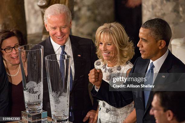 Vice President Joe Biden, his wife Dr. Jill Biden and President Barack Obama admire hand-cut and etched crystal vases created by Lenox given to them...