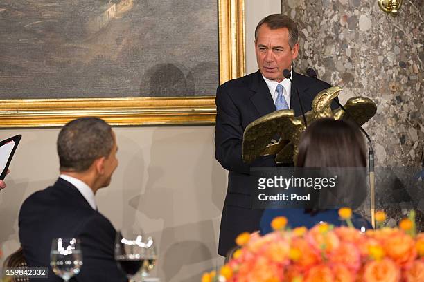 President Barack Obama listens to remarks by US House Speaker John Boehner during the Inaugural Luncheon in Statuary Hall on Inauguration day at the...