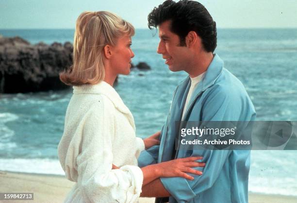 Olivia Newton John and John Travolta embrace on the beach in a scene from the film 'Grease', 1978.