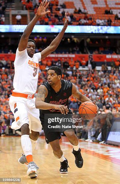 Jaquon Parker of the Cincinnati Bearcats drives to the basket against Jerami Grant of the Syracuse Orange during the game at the Carrier Dome on...