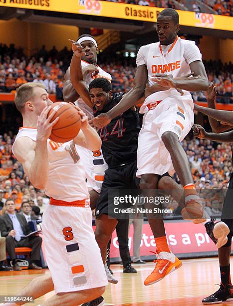 Trevor Cooney, Baye Moussa Keita and C.J. Fair of the Syracuse Orange fight for the rebound against Jaquon Parker of the Cincinnati Bearcats during...