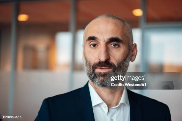 mature businessman with beard in office - arab men stock pictures, royalty-free photos & images