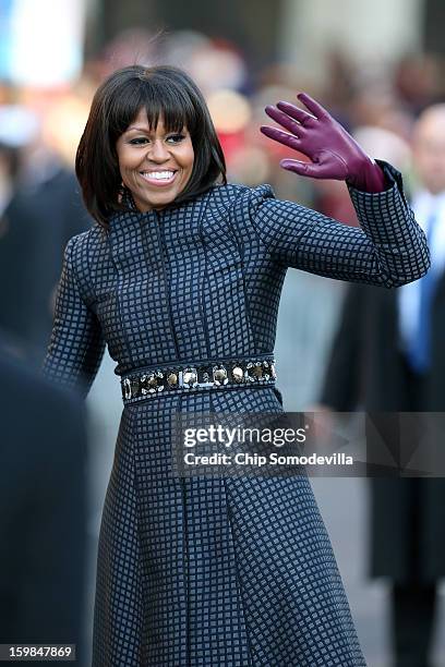 First lady Michelle Obama waves as the presidential inaugural parade winds through the nation's capital January 21, 2013 in Washington, DC. Barack...