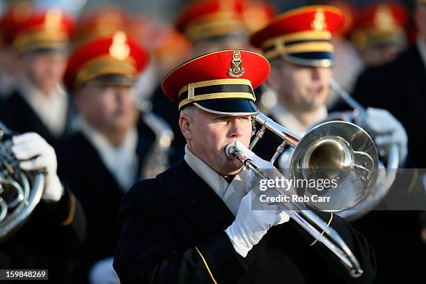 Military marching band passes near the White House as the presidential inaugural parade winds through the nation's capital January 21, 2013 in...