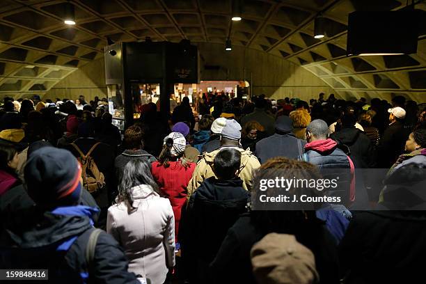 Crowds in route to the National Mall depart the L'Enfant Plaza Metro station to watch the 57th United States Presidential Inauguration ceremony on...