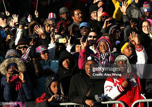 Spectators watch the inaugural parade on Pennsylvania Avenue January 21, 2013 in Washington, DC. Barack Obama was re-elected for a second term as...