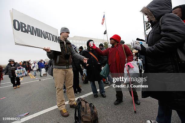 Street preacher debates with spectators enroute to watch the 57th United States Presidential Inauguration ceremony at the National Mall on January...