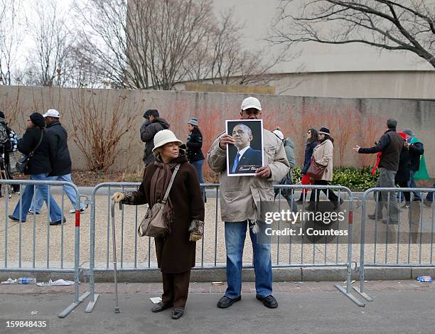 Barack Obama supporter holds up a poster as crowds traverse D. St. NW to watch the 57th United States Presidential Inauguration ceremony on January...