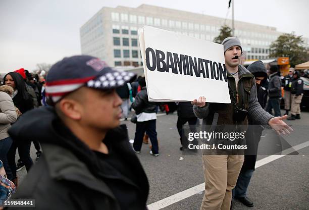 Street preacher debates with spectators enroute to watch the 57th United States Presidential Inauguration ceremony at the National Mall on January...