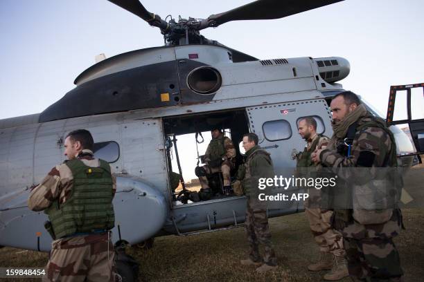 French soldiers from various units of the Air Force, Ground Army and the French Forein Legion prepare to board a chopper, amongst a group of five...