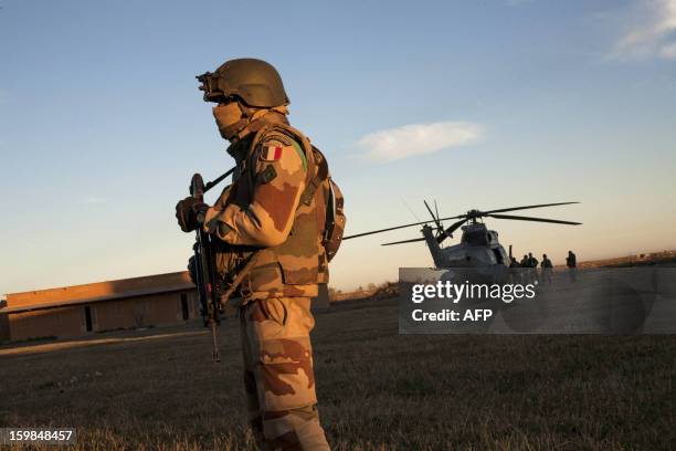 French Foreign Legion soldier stands guard as groups from various units of the Air Force, Ground Army and the French Foreign Legion prepare to fly...