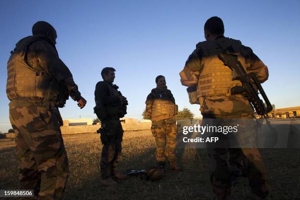 Group of French soldiers chat at an improvised helipad as groups from various units of the Air Force, Ground Army and the French Foreign Legion fly...
