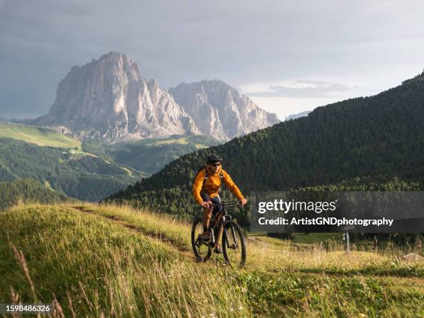 mountain biking in dolomites secede,italy. - mid adult stock pictures, royalty-free photos & images