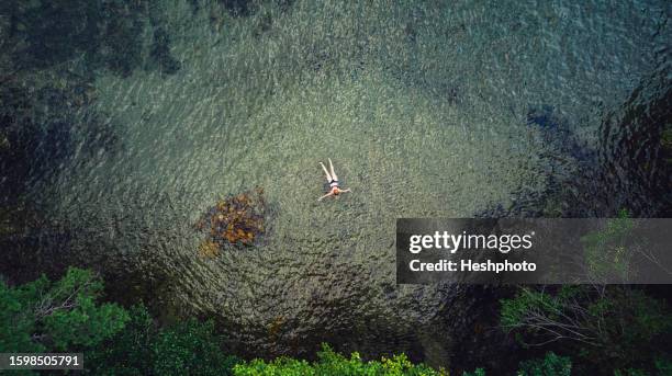 usa, new york state, hague, flirtation island, woman swimming in lake george - lake george new york fotografías e imágenes de stock