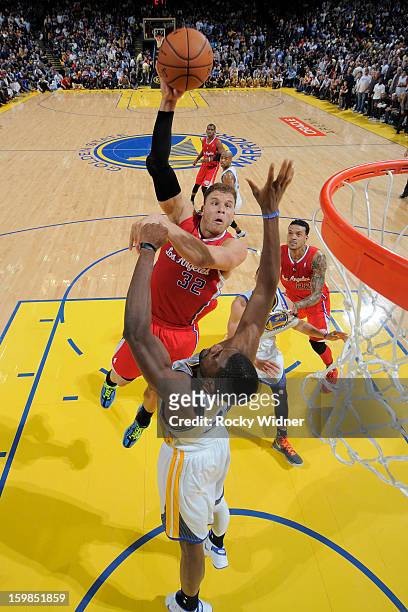 Blake Griffin of the Los Angeles Clippers shoots against Festus Ezeli of the Golden State Warriors on January 21, 2013 at Oracle Arena in Oakland,...
