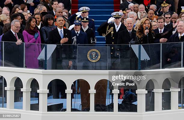 President Barack Obama and Vice President Joe Biden listen as singer Beyonce sings the national anthem at the ceremonial swearing-in during the 57th...