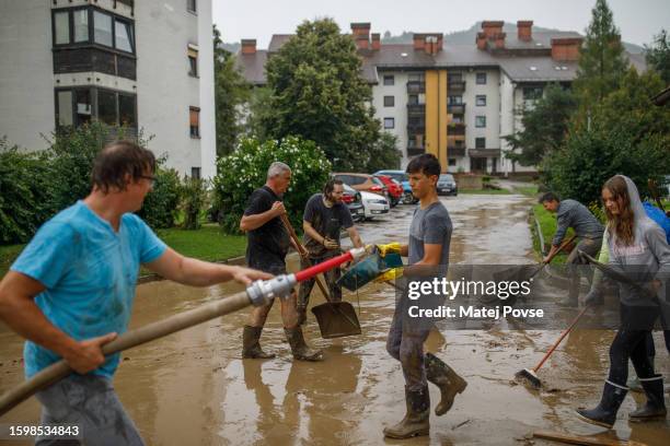 Group of residents cleans an apartment block that was flooded by the Savinja River on August 5, 2023 in Nazarje, Slovenia. Deemed as the worst...