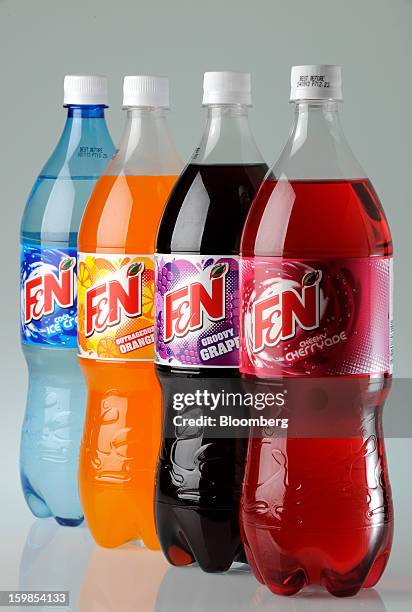 Bottles of Fraser & Neave Ltd.'s F&N sparkling drink in various flavors are arranged for a photograph in Singapore, on Monday, Jan. 21, 2013....