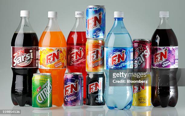Bottles and cans of Fraser & Neave Ltd.'s F&N sparkling drink in various flavors are arranged for a photograph in Singapore, on Monday, Jan. 21,...