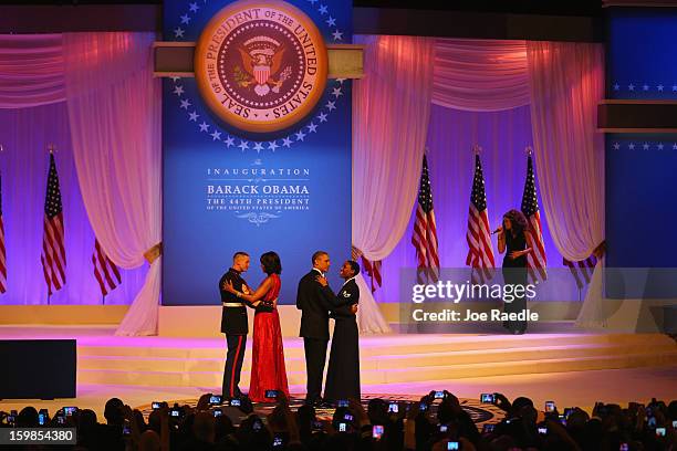 President Barack Obama dances with Air Force Staff Sergeant Bria Nelson as first lady Michelle Obama dances with Marine Gunnery Sergeant Timothy...