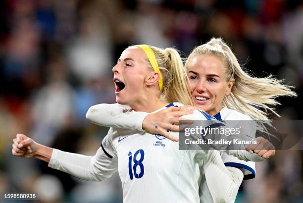 Chloe Kelly of England celebrates with teammate Alex Greenwood after scoring her team's fifth and winning penalty in the penalty shoot out during the...