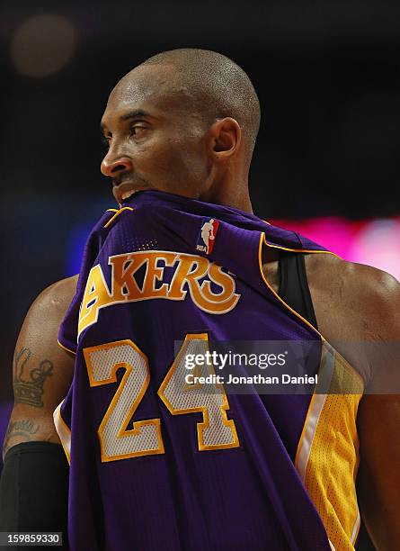 Kobe Bryant of the Los Angeles Lakers bites his jersey during a game against the Chicaog Bulls at the United Center on January 21, 2013 in Chicago,...