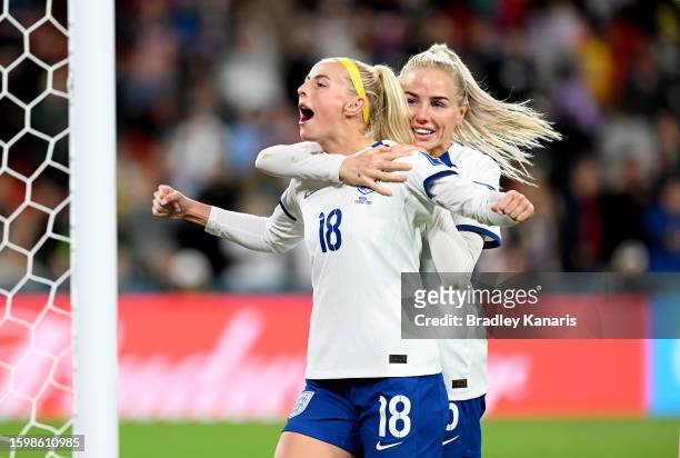 Chloe Kelly of England celebrates with teammate Alex Greenwood after scoring her team's fifth and winning penalty in the penalty shoot out during the...