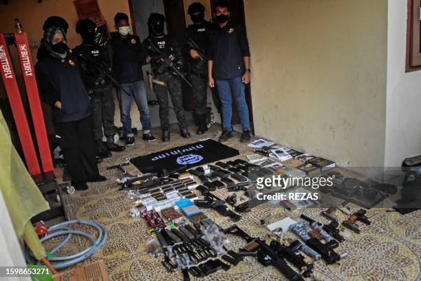 Indonesian Anti-terror Squad shows seized firearms and items allegedly related to the Islamic State of Iraq and Syria from the house of a suspect who...